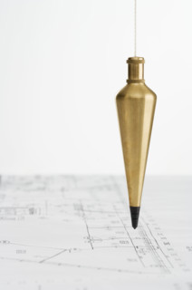 Plumb bob with blueprints.