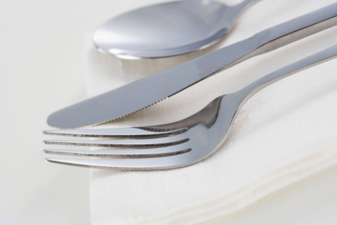Still life of silverware and napkin.