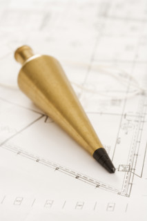 Plumb bob with blueprints.