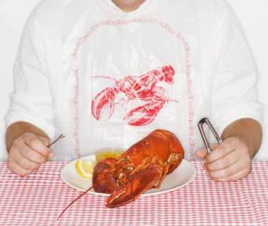 Man eating a lobster.