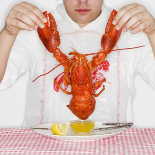 Man dining with an entire lobster.