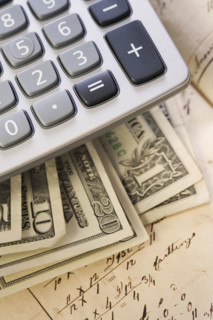 Still life of US money and calculator.