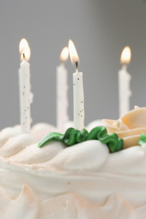 Lit candles on a birthday cake.