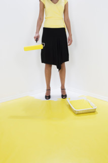 Woman painting herself into a corner.