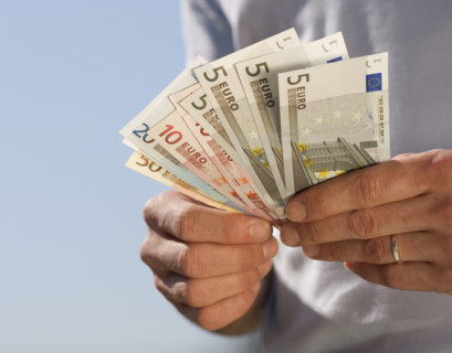 Hand holding Euro notes.