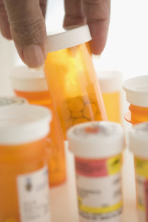 Hand selecting prescription drugs.