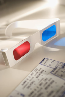 Still life of 3-D glasses and movies tickets.
