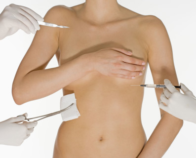 Nude female torso with medical instruments.