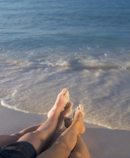 Couple relaxing on beach.