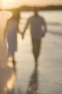 Couple strolling on a beach.
