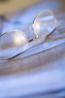 Still life of reading glasses and documents.