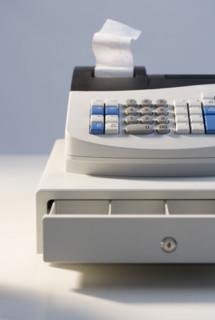 Cash register with open drawer.