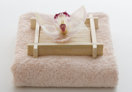 Still life of orchid on terry cloth.
