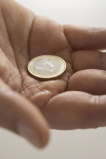 Closeup of Euro coin in palm.