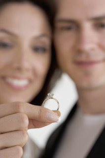 Closeup of blurred couple with ring.