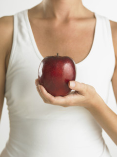 Closeup of woman holding apple.