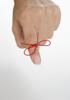 String tied around woman's finger.