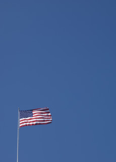 American flag against blue sky.