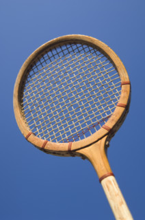 Closeup of an antique tennis racquet.