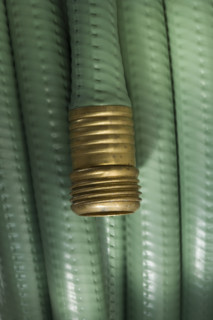 Closeup of wound up garden hose.