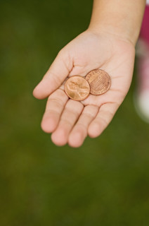 Closeup of pennies in childs palm.