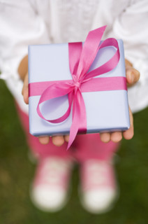 Closeup of a present in a childs hands.