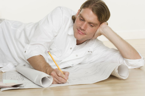 Man looking at blueprints.