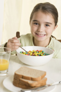 Young girl eating breakfast cereal.