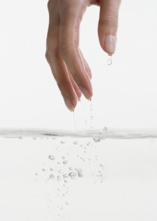 Hand touching water.