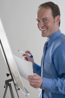 Portrait of businessman at presentation board.