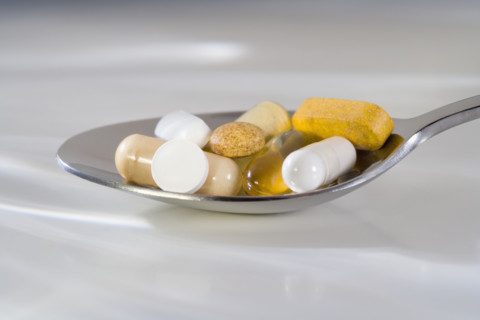 Still life of a spoonful of pills.
