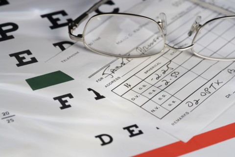 Still life of eye chart and glasses.