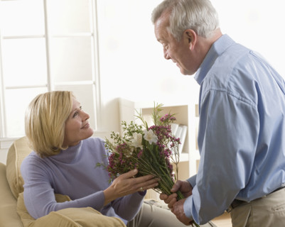 Man giving flowers to his wife.