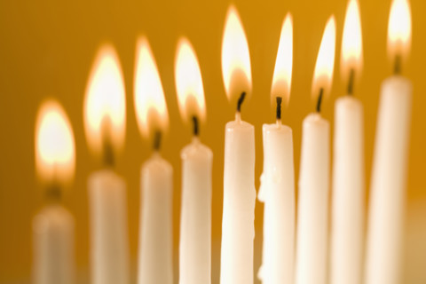 Candles burning in a menorah.