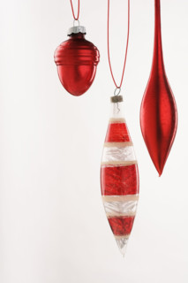 Three hanging Christmas ornanaments.