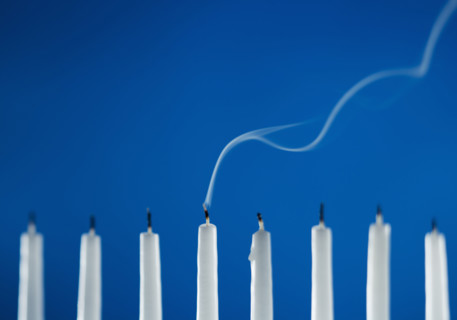 Extinguished candles in a menorah.