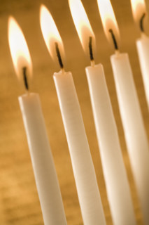 Candles burning in a menorah.