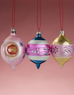 Three hanging Christmas ornanaments.