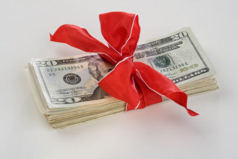 A stack of money with a bow.