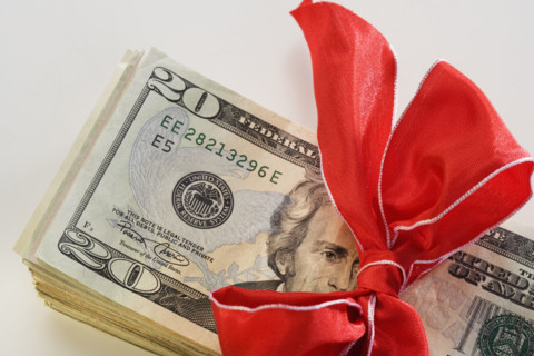 A stack of money with a bow.