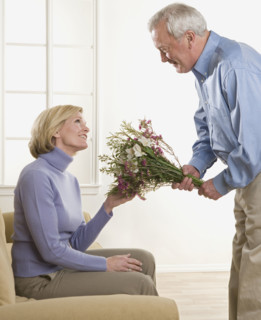 Man giving flowers to his wife.