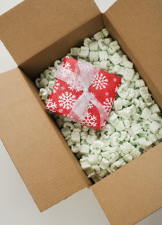 Still life of box of Styrofoam with gift.