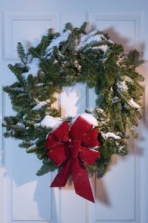 Still life of Christmas wreath on door.