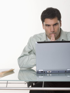 Man working at a computer.