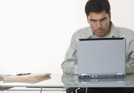Man working at a computer.