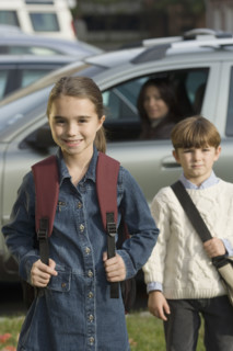 Mother dropping children off at school.