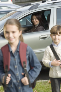Mother dropping children off at school.