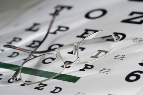 Still life of eye chart and glasses.