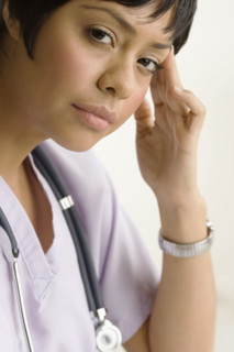 Profile view of a concerned health practitioner.