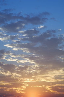 Sunset with puffy clouds.